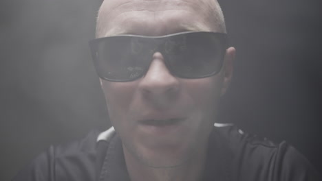 man with sunglasses and smoke