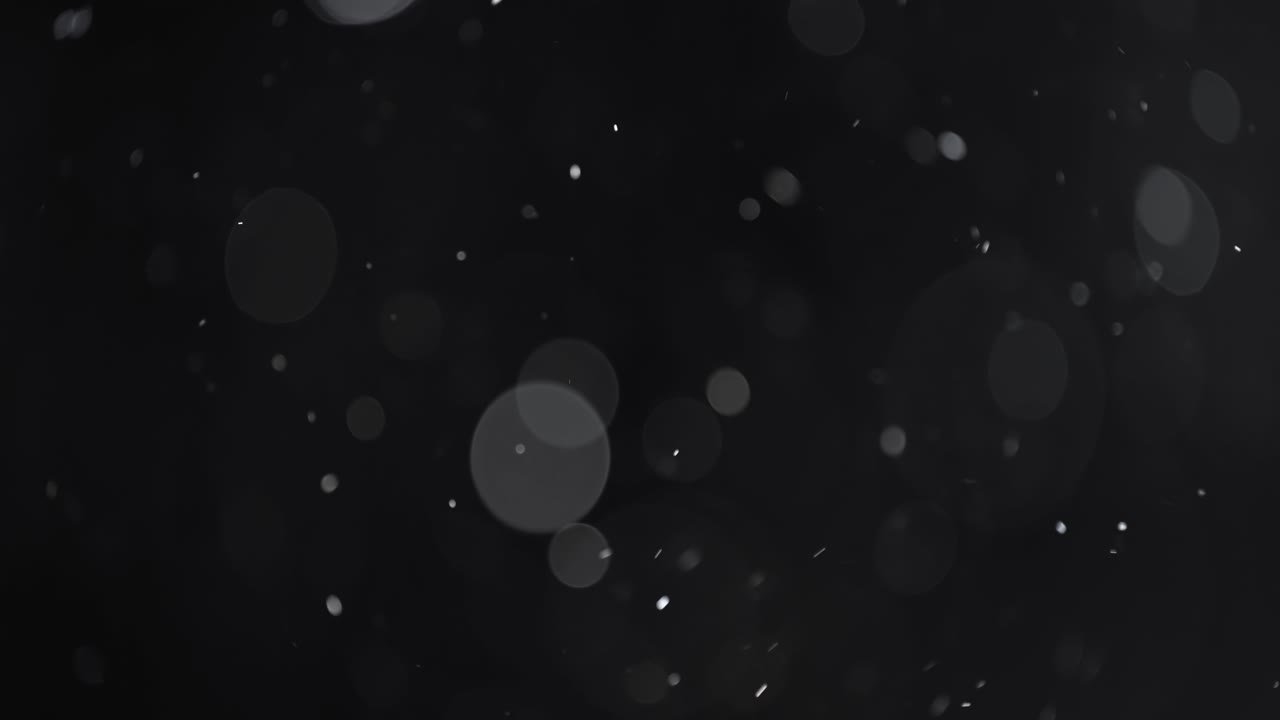 bokeh di particelle astratte galleggianti su sfondo scuro