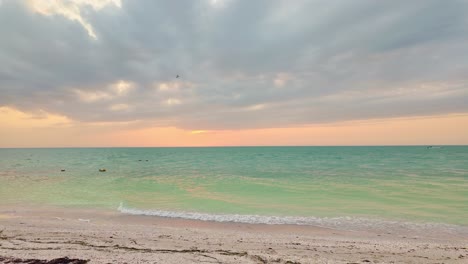 serene beach sunset with turquoise water in holbox punta cocos, mexico