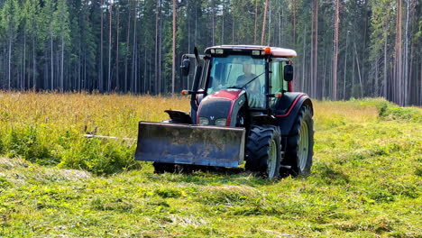 slow motion shot of worker farming with tractor vehicle in the woods at daylight