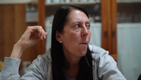 Older-Woman-Eating-While-Watching-Television-At-Home