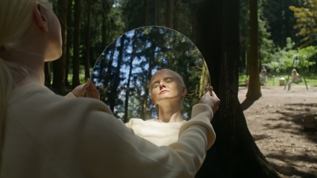 Woman Holding Mirror in Forest