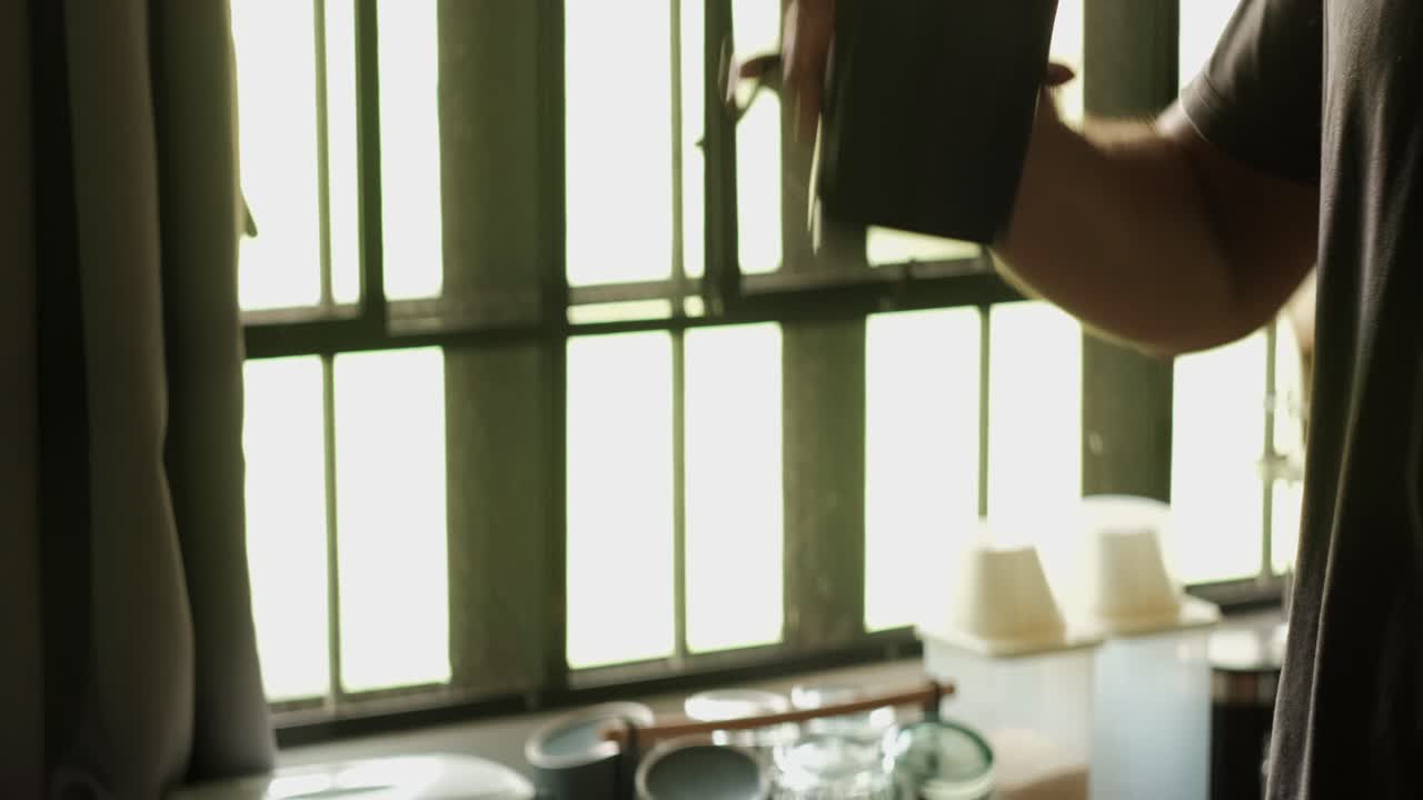Hand shaking protein shaker bottle and drinking with apartment window backdrop - close-up static shot