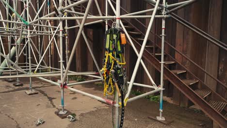 push in shot of scaffold safety climbing equipment and harness hanging on scaffolding