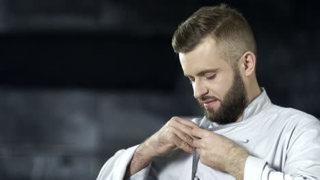 chef man preparing to cook at professional kitchen. portrait of happy male cook