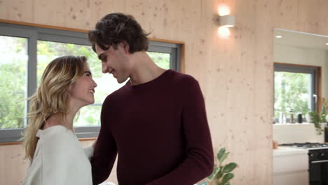 christmas time, dancing joyfully at home, couple sharing loving moment together in living room