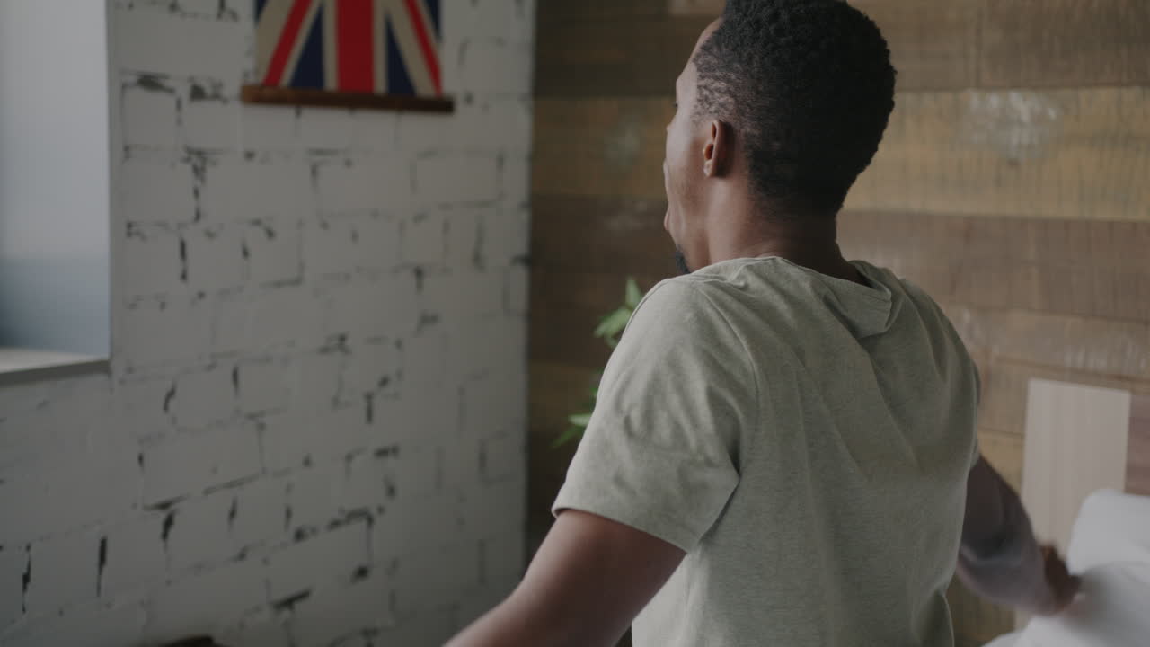 Man Stretching in His Bedroom