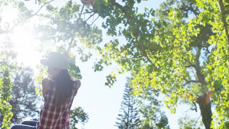 woman playing with hanging rope in the park 4k