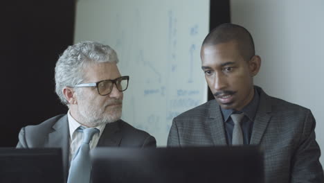 diverse male office colleagues working at workplaces