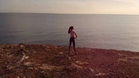 360 degrees aerial view of woman looking at sea after workout