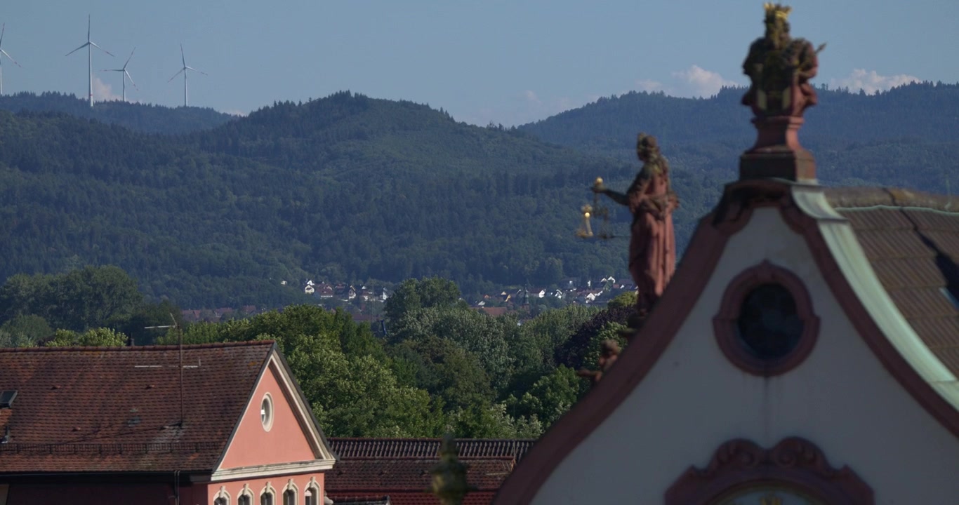 Old Buildings with mountains and Windmills in Background 2 - SLOMO - RACK FOCUS