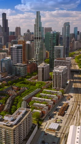 busy multi-lane motorways near soldier field stadium on the near south side of chicago, illinois, united states. skyscrapers against cloudy blue sky at backdrop. vertical video