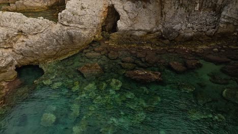 underwater caves on the rocky coast of kalamota island near dubrovnik, adriatic sea, croatia