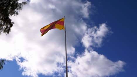 the flag of the swedish church waiving in the wind shot from below