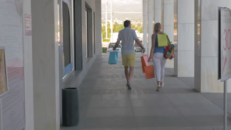 Young-people-leaving-trade-centre-being-happy-with-shopping