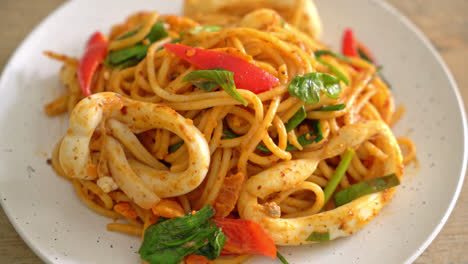 stir-fried spaghetti with salted egg and squid - fusion food style