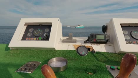 steering wheel and navigation compass on a yacht background of red sea