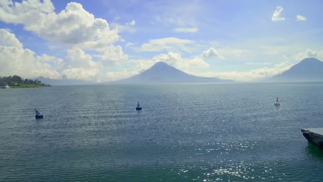 aerial over lake amatitlan in guatemala reveals the pacaya volcano in the distance