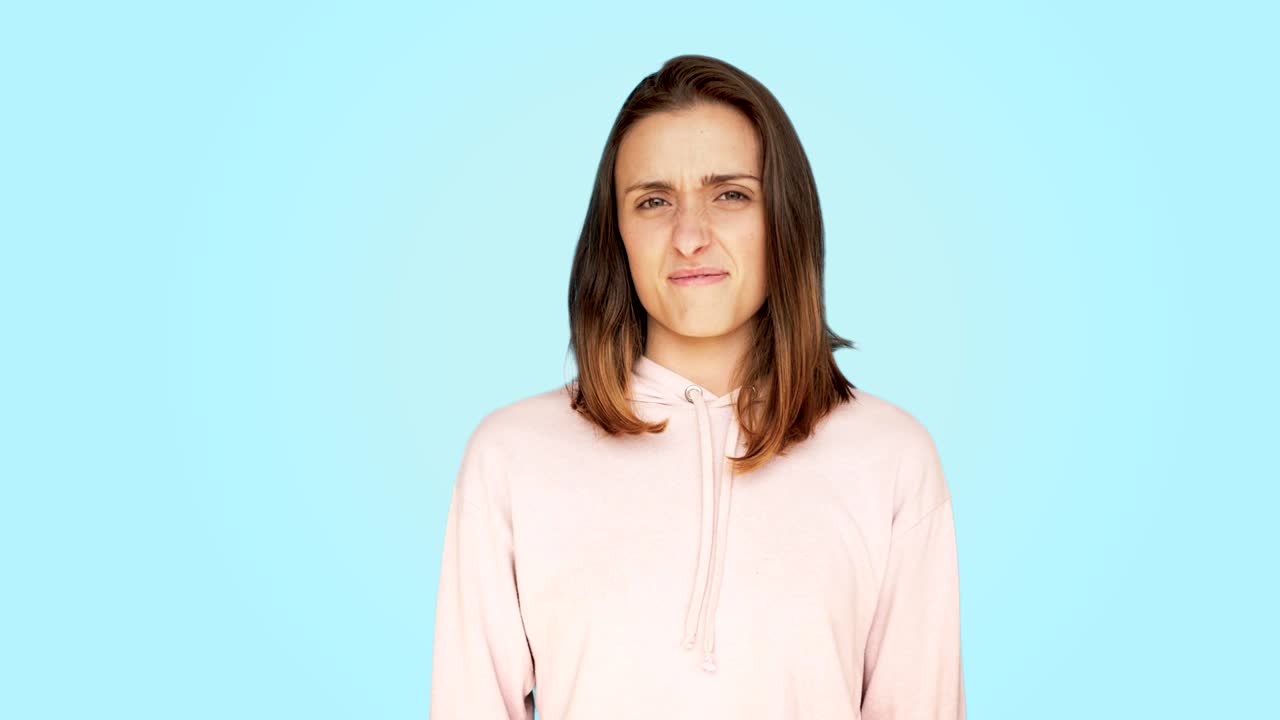 Disgusted and grossed off woman makes grimace