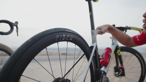 young professional athlete man fixing his bike's tire.