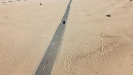 slow motion fpv drone clip of off road car in the desert