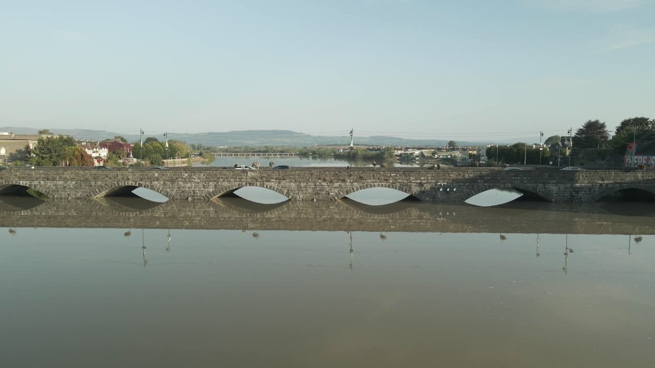 Limerick, ireland in early morning with a river, bridge, and king john's castle in sight, aerial view