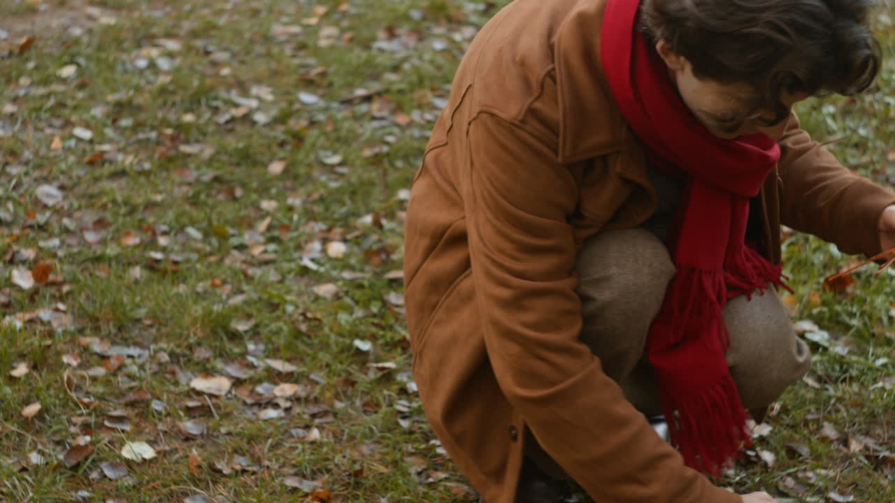 Man in Autumn Collecting Leaves