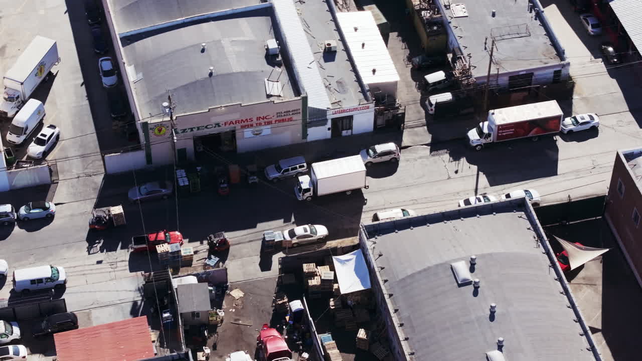 Aerial View of an Industrial Area with Warehouses and Trucks