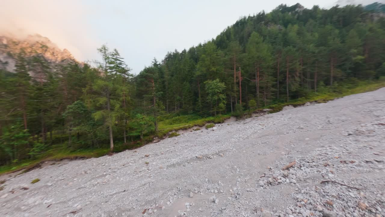 FPV drone flight over dry riverbed in Gesäuse National Park Austria