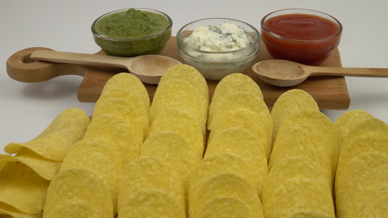 Bowls with different sauce and potato chips