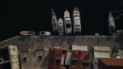 top down aerial view of classic boats and yachts parked in the port of milna village, brac island, croatia