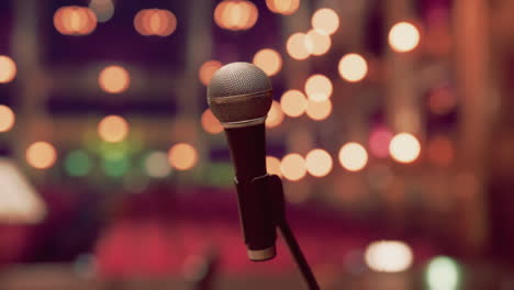 a microphone on a stage with lights in the background