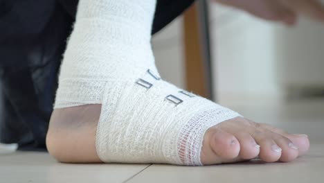 Woman-with-bandaged-foot-close-up-,