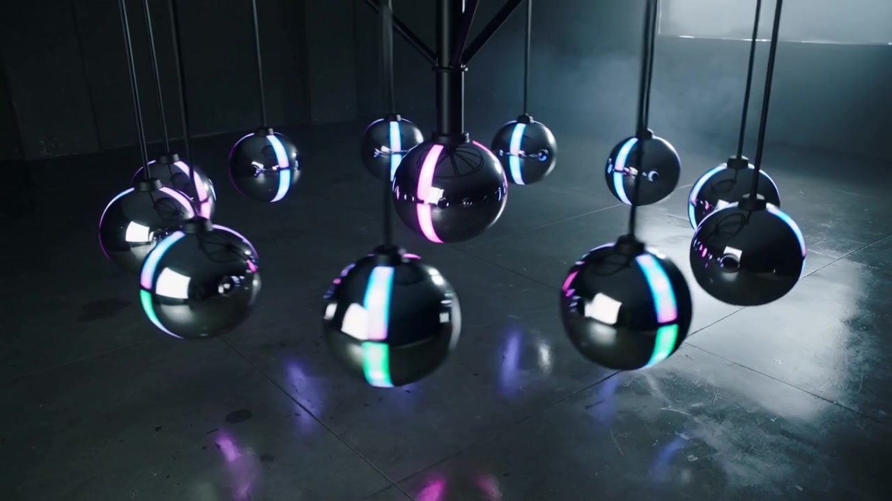 Camera pulling back, swinging chrome spheres making cyan magenta ripples under mast dim studio