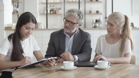 Three-partners-signing-contract,-handshaking-and-enjoying