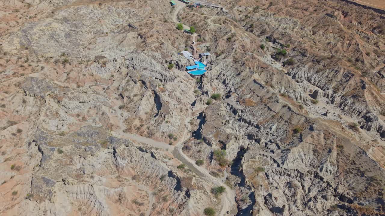 The drone soars above the sculpted relief of the Tatacoa Desert, revealing layered ridges and dramatic desert formations. A cinematic aerial highlighting Colombia’s raw, otherworldly terrain