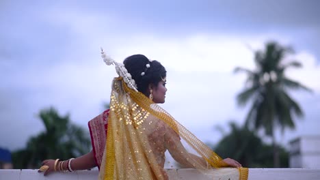 Sad-and-upset-Indian-Bengali-bride-looking-at-dark-cloudy-sky-on-monsoon-evening