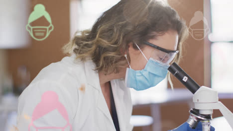 Woman-wearing-face-mask-icons-floating-against-female-health-worker-holding-covid-19-vaccine