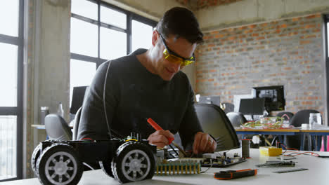 male electrical engineer soldering a circuit board 4k