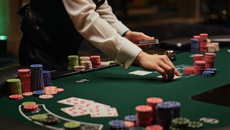 a dealer shuffles and deals cards at a casino table with poker chips