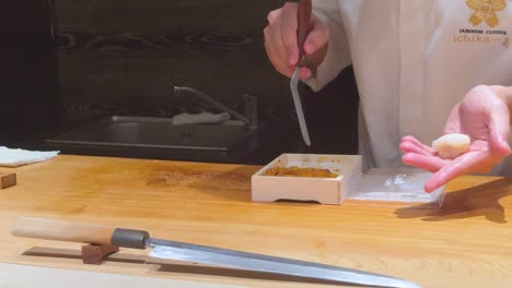 chef skillfully prepares sushi with precision and care