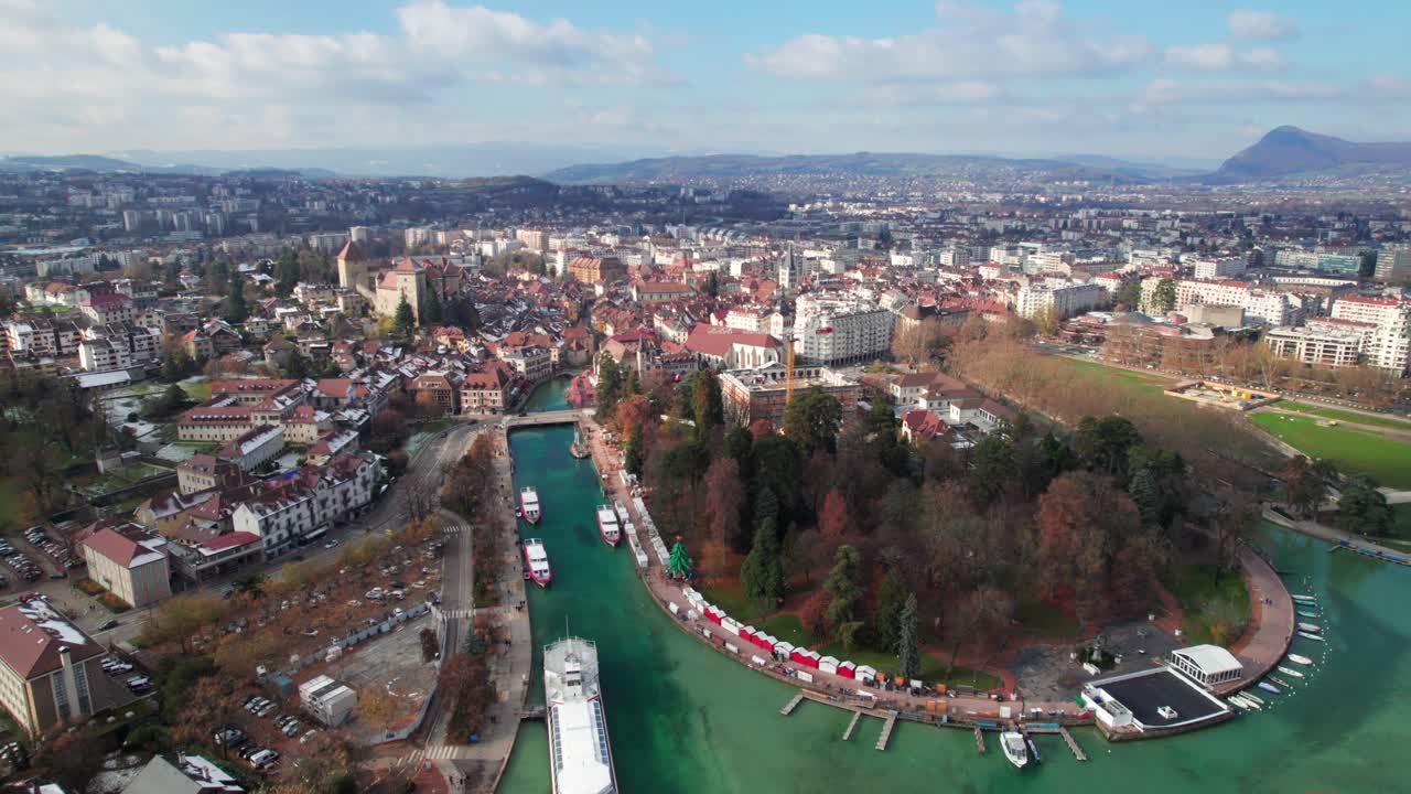 Annecy, France. Long aerial of old town skyline, canals and lakefront, 4K