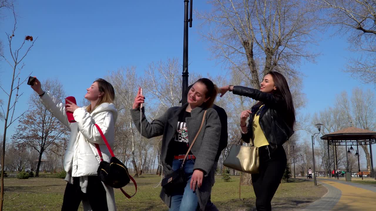 Teenagers walks in park and sings to the beat of music