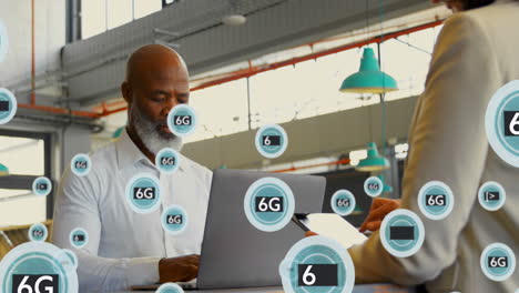 animation of 6g texts and symbols over diverse coworkers using laptop and digital tablet