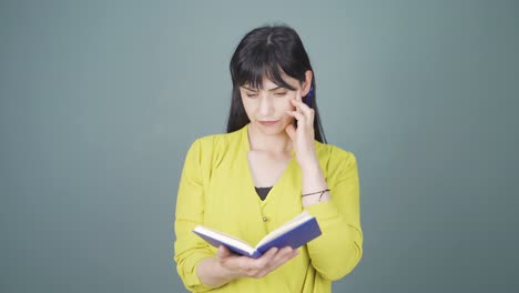 woman with notebook thinks and takes notes.