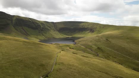 llyn y fan fach beautiful brecon beacons mountain lake scenic valley countryside aerial view landscape slow push in