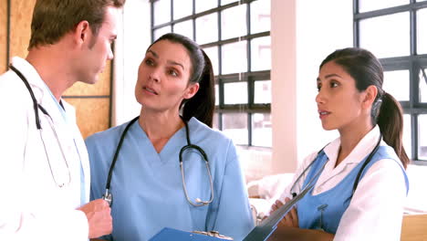 Doctors-discussing-the-report-on-clipboard