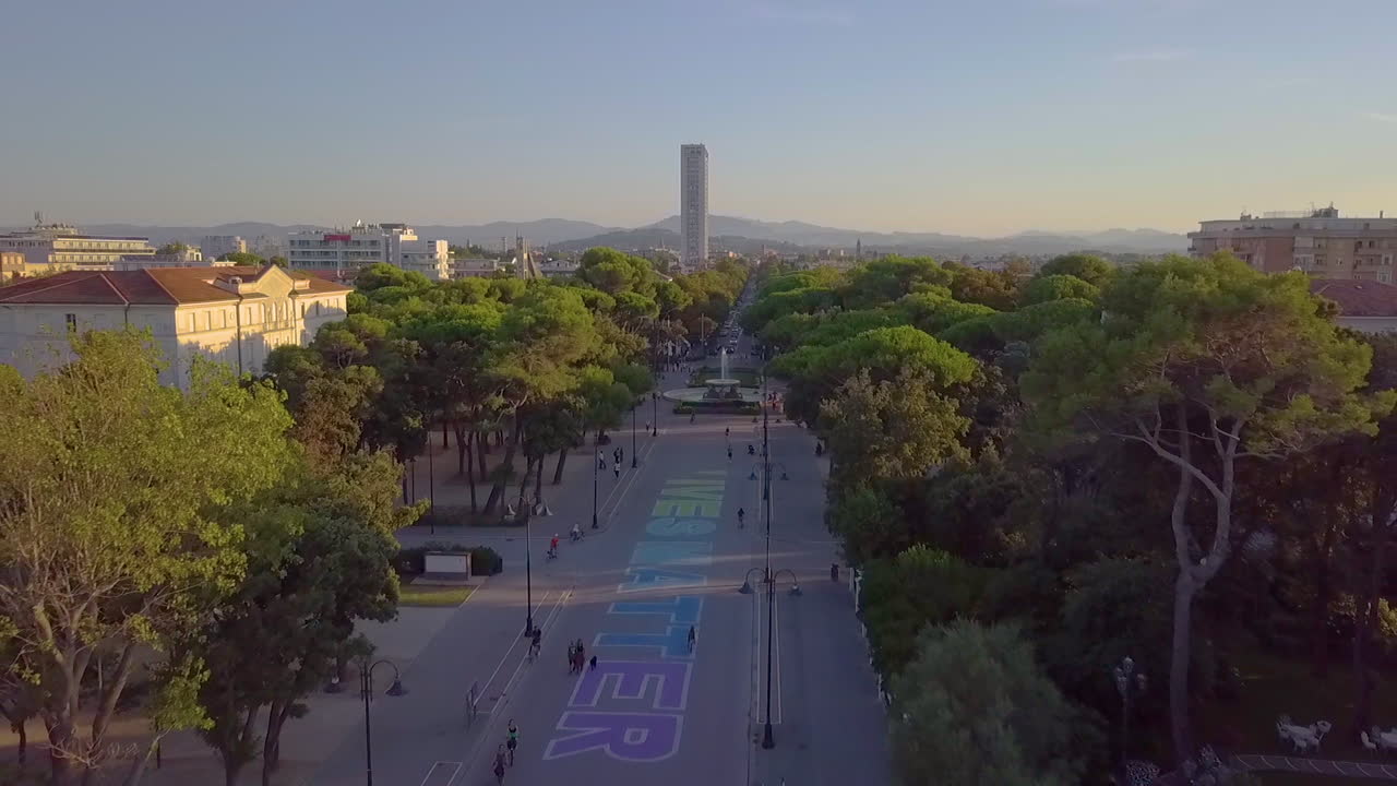 Aerial View Of The Fountain Of The Four Horses In Marina Centro, Rimini, Italy With Tall Apartment Complex In Distant Background. drone pullback