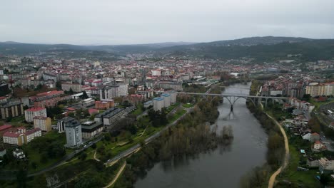 panoramic aerial establishing view of ourense in galicia, spain uner dark grey winter skies