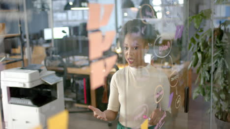 Young-African-American-woman-stands-in-a-modern-business-office